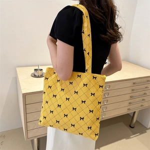 Sac fourre-tout minimaliste en velours côtelé jaune avec motif à nœuds noirs