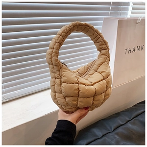 Detailed close-up of khaki quilted puffy cloud bag showing ruched handle and texture