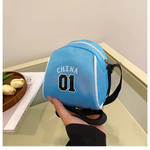Detailed macro view of the small blue sports crossbody bag with CHINA 01 lettering and zipper