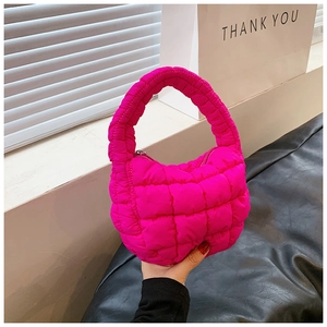 Close-up detail of hot pink quilted bubble handbag with soft puffy polyester texture
