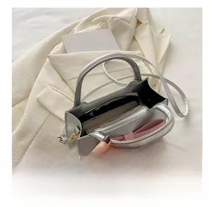 Interior view of the silver handbag showing large capacity with a central zip pocket
