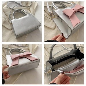 Detail view of silver leather handbag with pink bow, showing interior and structure
