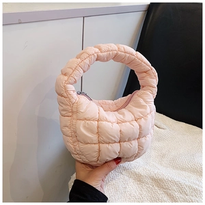 Close-up of pink quilted bubble cloud bag showing soft padded texture and silver zipper