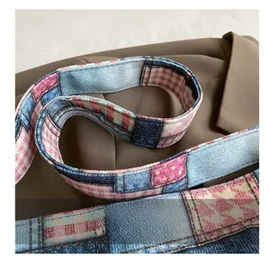 Detail of multi-fabric patchwork shoulder strap with denim and plaid patterns