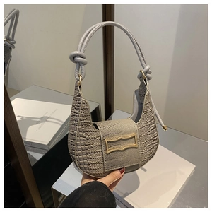 Close-up of grey crocodile pattern hobo bag with gold buckle and knotted handle details