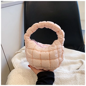 Detail showing light pink quilted cloud bag with puffy texture and zip closure