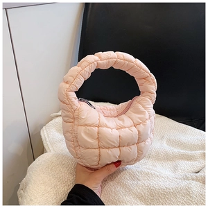 Close-up of pink quilted cloud bag featuring soft texture and stylish stitching details