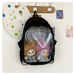 Detailed view of black canvas ITA bag featuring a clear window with cute plush dolls inside