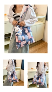 Detail of patchwork denim tote bag with pink plaid pattern and cute plush bunny charm
