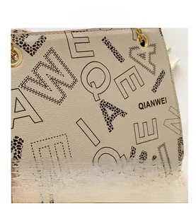 Macro shot of beige lychee texture with leopard print QIANWEI letter detailing