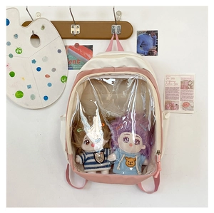 Detailed view of pink ita bag with transparent window displaying cute plush dolls inside
