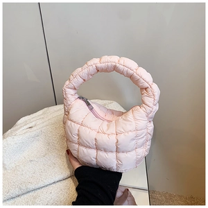 Detailed close-up of pink quilted cloud bag featuring smooth metal zipper and soft textures