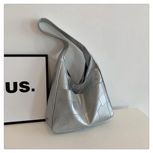 Detail of silver geometric hobo bag with metallic leather texture and wide strap