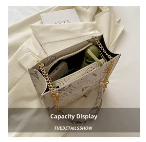 Detailed interior view of a white tote bag showing capacity for phone, wallet and umbrella