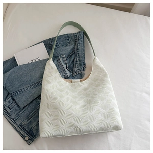 Close-up of the textured woven hobo bag fabric with a light green shoulder strap detail
