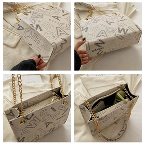 Detail showing the large interior capacity and leather texture of the white handbag