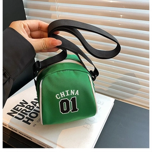 Close-up of green canvas mini crossbody bag with CHINA 01 print and adjustable strap
