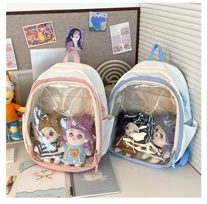 Detail of two canvas ita bags with transparent windows for plush doll display
