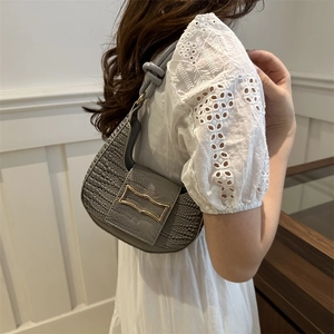 Grey crocodile embossed leather hobo bag with gold metal buckle and knotted shoulder strap