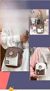 Detail of canvas messenger bag with cute animal badge and adjustable shoulder strap