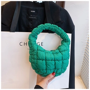 Detailed macro view of the grass green quilted cloud bag with puffy nylon texture