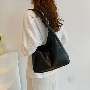 Minimalist black large hobo shoulder bag with geometric texture for daily commute