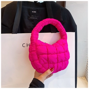Detailed close-up of hot pink ruched cloud bag showing quilted nylon texture and square stitching