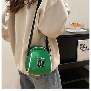Detail view of the green mini crossbody bag showing China 01 logo and canvas texture