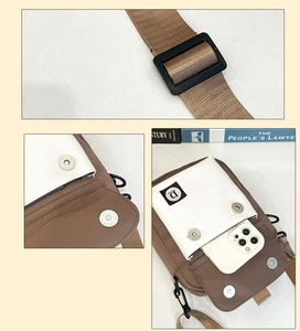 Detail showing durable canvas mobile phone bag with adjustable strap and magnetic closure