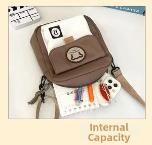 Detail showing the large capacity and interior storage of the brown canvas crossbody bag