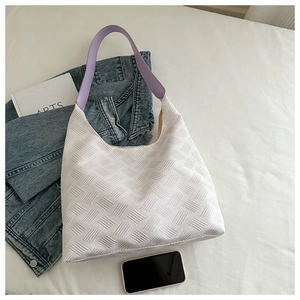 Detail showing white textured leather Hobo bag with lavender strap and woven patterns