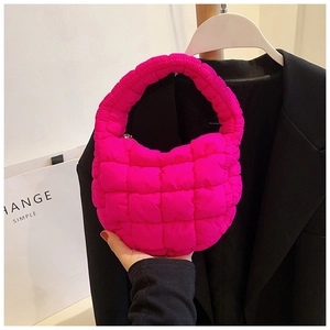 Detailed macro view of the rose red quilted puffy cloud bag with soft fabric texture