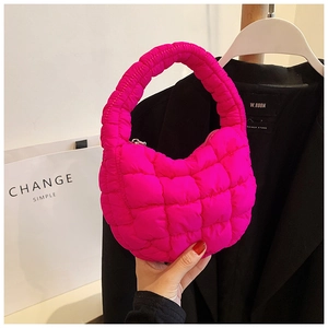 Detailed close-up of neon pink quilted bubble handbag in pleated nylon material