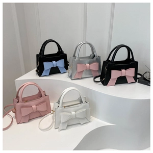 Detailed display of five colors of mini leather handbags with large decorative bowknots
