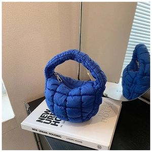 Close-up of klein blue quilted cloud bag with soft nylon fabric and square stitching