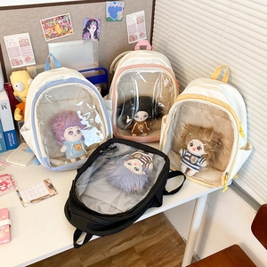 Detail of four colorful Ita bags with clear PVC windows for doll display and storage