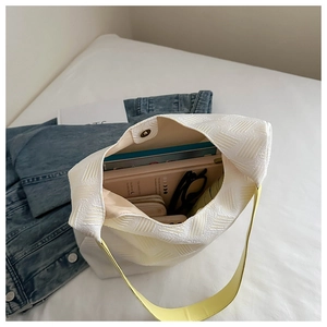 Interior view of beige textured tote bag showing large capacity for books and accessories