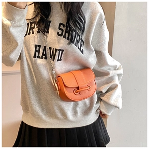 Detail of orange pebble leather crossbody bag with silver bead chain and strap buckle