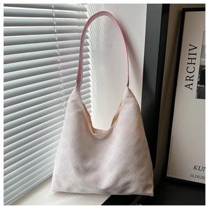 Detail view of pink textured bubble fabric hobo bag with sleek leather shoulder strap