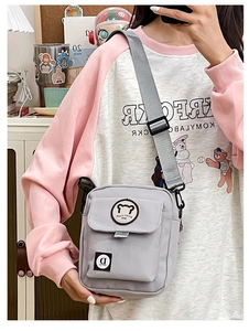 Gray canvas messenger bag with cute bear patch and adjustable strap for student casual wear
