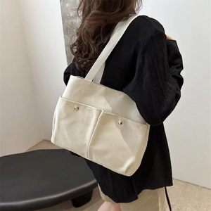 Large off-white canvas tote bag with front pockets for daily commute and students