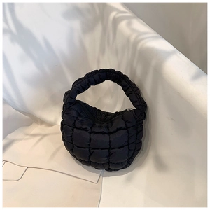 Close-up of black quilted cloud bag showing puff square texture and nylon fabric