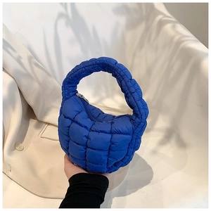 Detail of Klein blue quilted puffer bag showing the soft texture and zipper closure