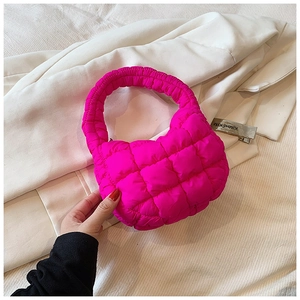Detail of hot pink quilted cloud handbag showing pleated texture and nylon fabric