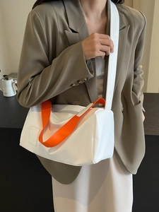 Minimalist white tote bag with orange handle and adjustable strap for women commuting