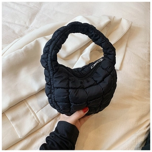 Detailed macro view of black quilted puffer fabric texture and high-quality metal zipper