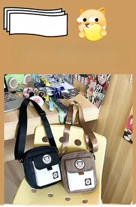 Detail showing canvas crossbody bags with flap closure and adjustable straps on a chair