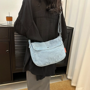 Retro light blue denim crossbody tote bag with adjustable strap and red woven label details