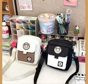Detail of cute Korean bear canvas crossbody bag with adjustable straps and logo patch