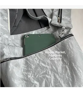 Detail of silver tote bag featuring functional zipper pocket and ample storage capacity